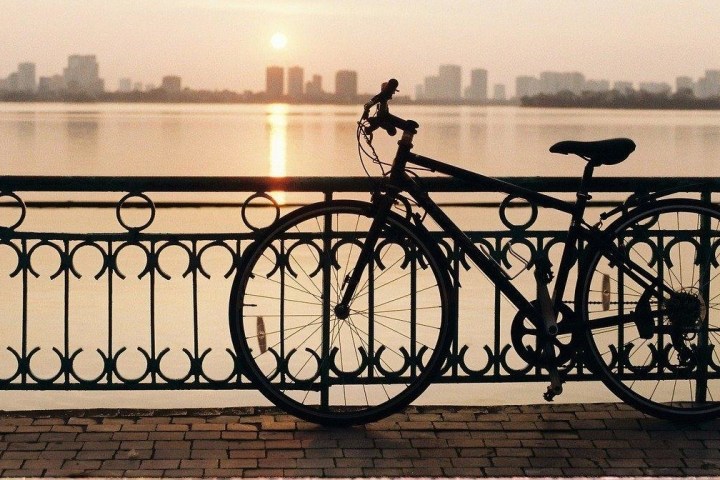 a bicycle is parked next to a body of water