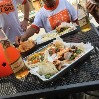 a group of people preparing food in a bowl