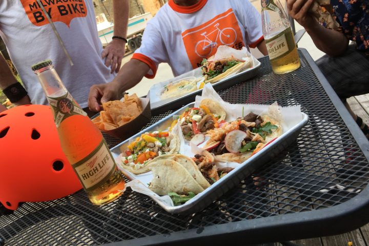 a group of people preparing food in a bowl